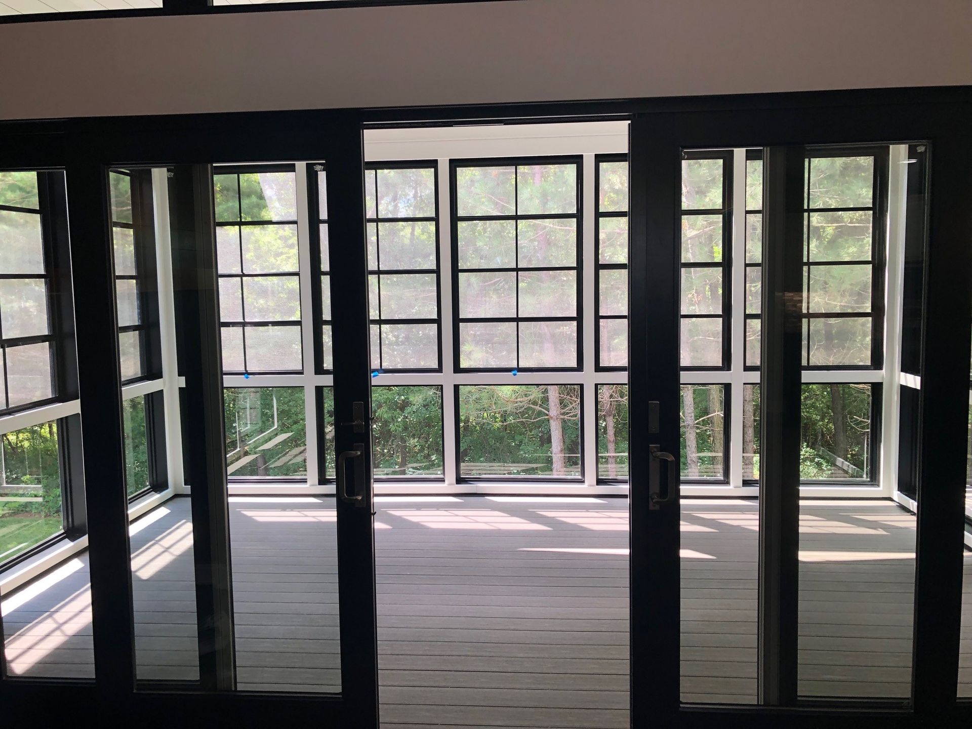 a room with a lot of windows and sliding glass doors