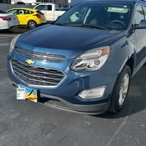 Blue Chevy Equinox parked on asphalt.