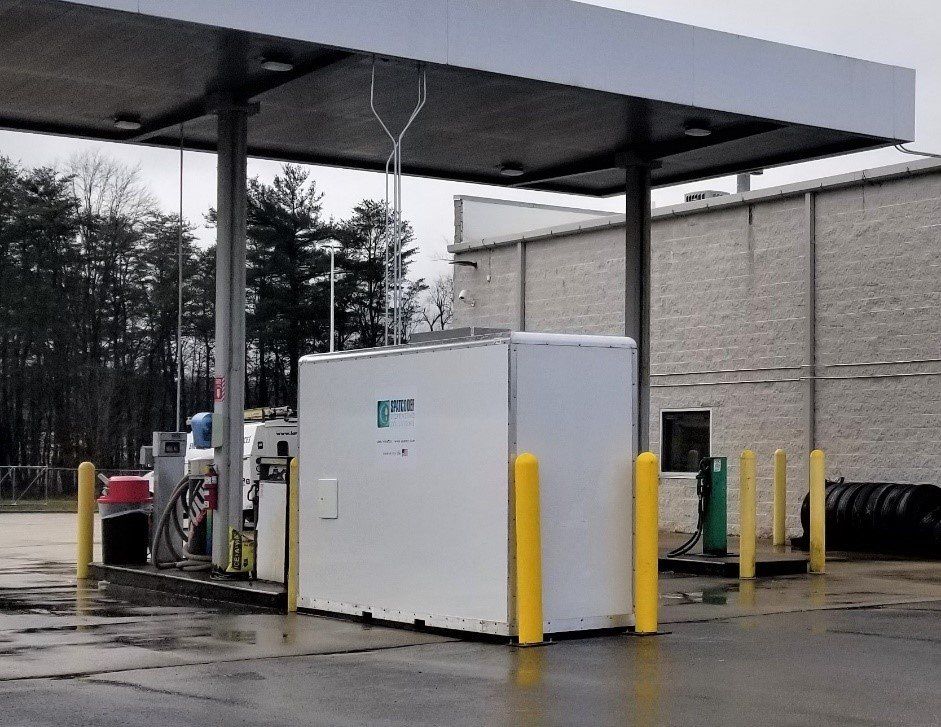 A gas station with a white container that says ' propane ' on it