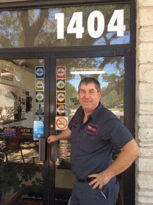 A man is standing in front of a door with the number 1404 on it
