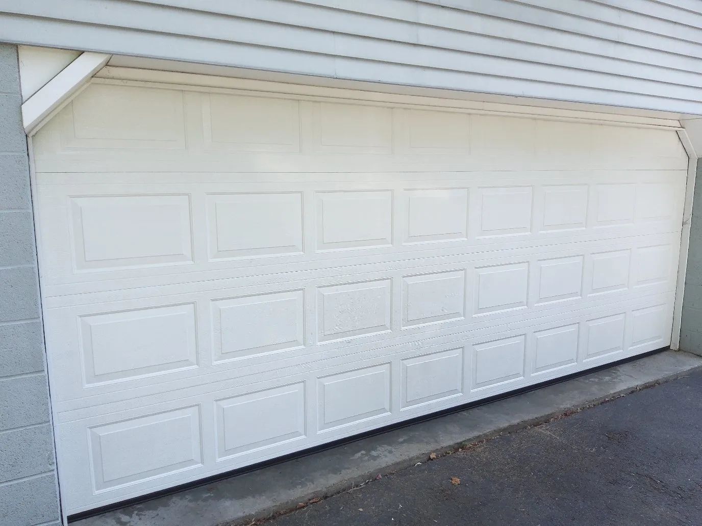 White two-car garage door on a house exterior