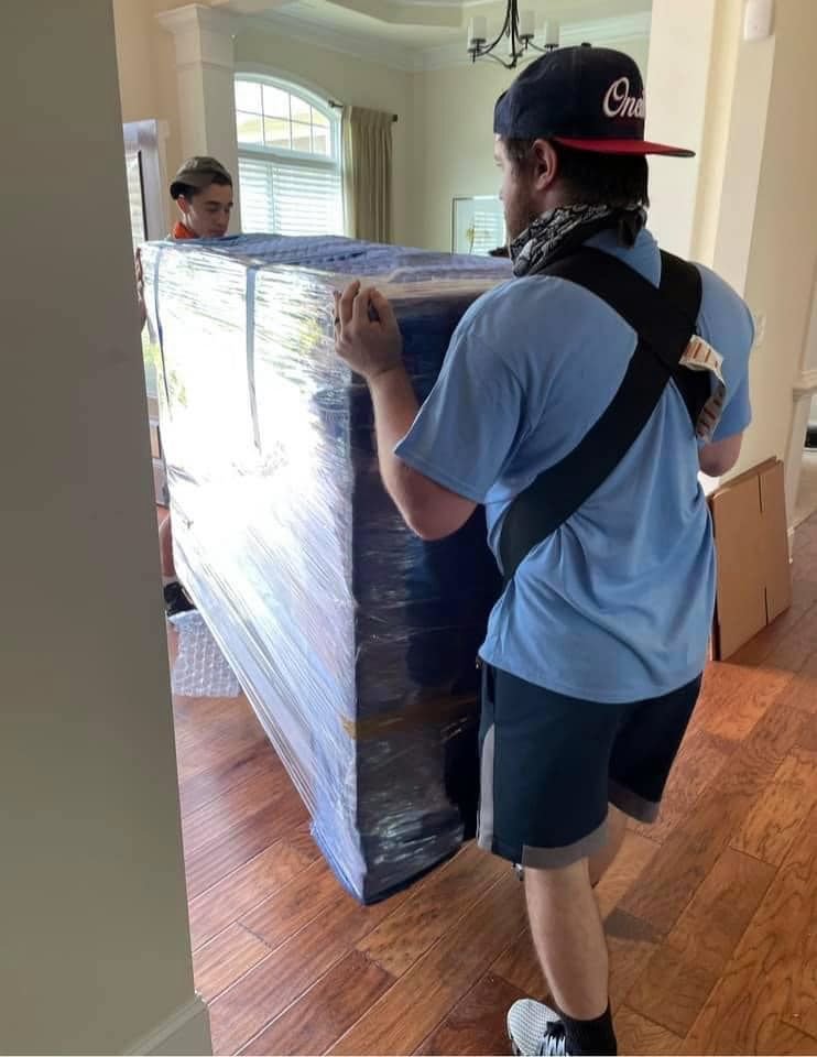 a man is carrying a large piece of furniture in a room