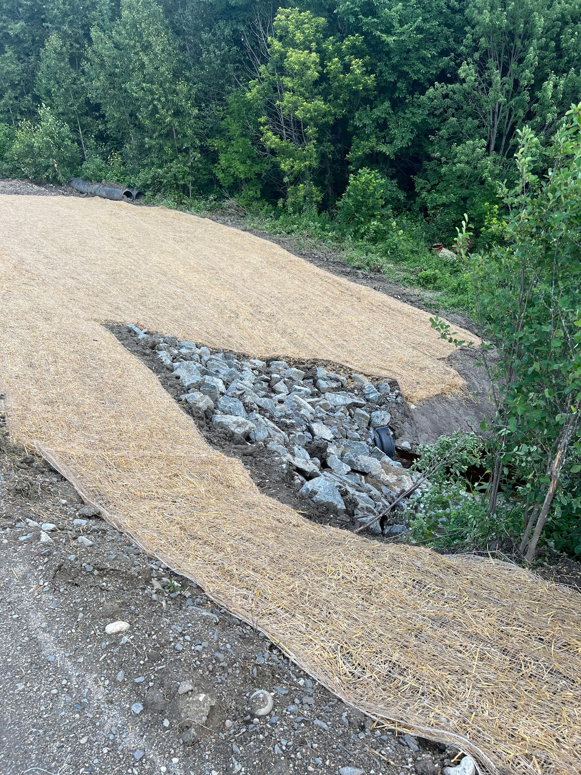 A pile of gravel and rocks on the side of a road.