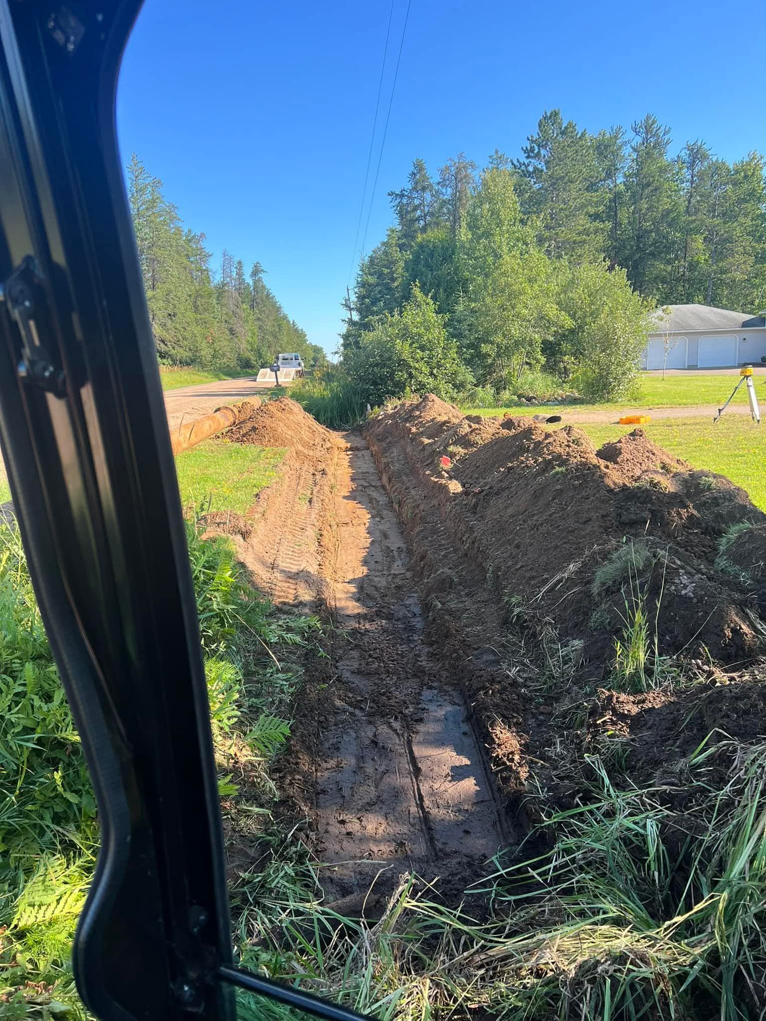 A large pile of dirt is sitting on the side of a road.