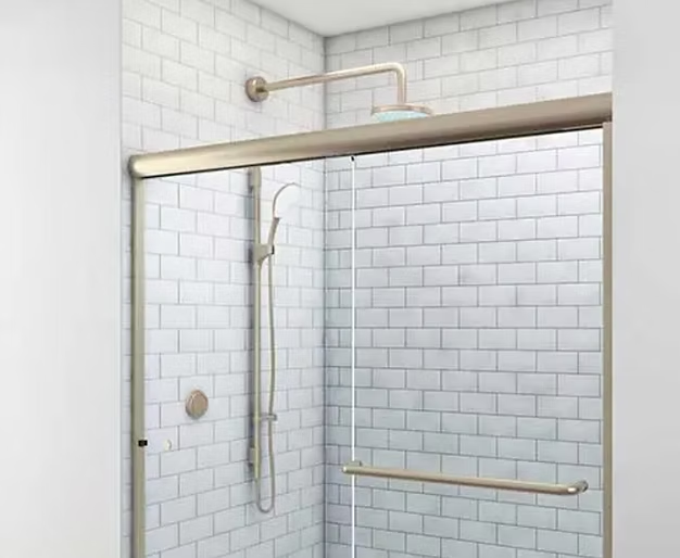 Shower stall with sliding glass doors, subway tile, and brushed nickel fixtures.
