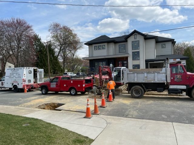 A dump truck is parked in front of a house