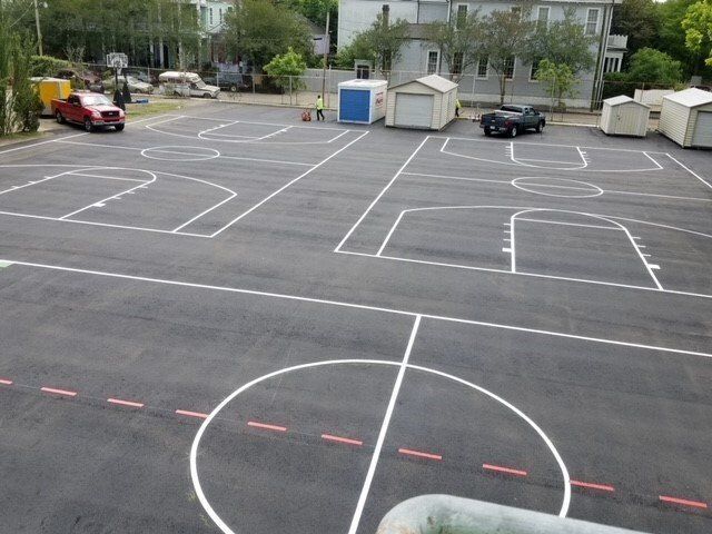 An aerial view of a basketball court in a parking lot