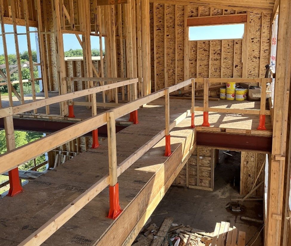 The inside of a building under construction with a wooden railing