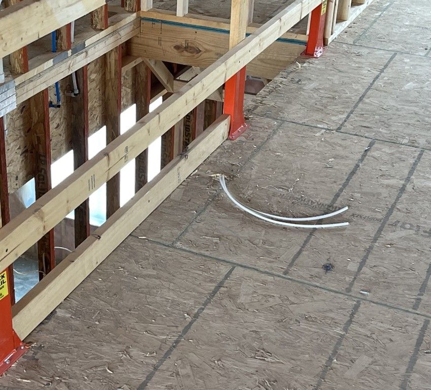 A broken pipe is on the floor of a building under construction