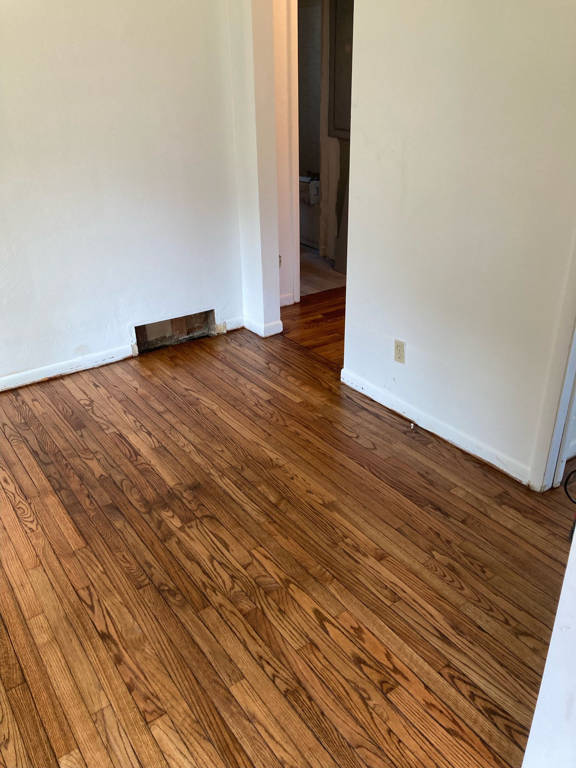 A room with a wooden floor and white walls