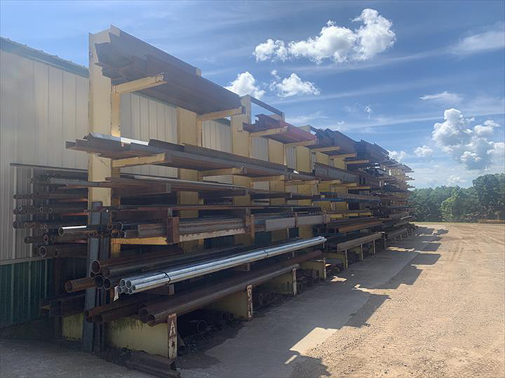 a large warehouse filled with lots of metal pipes .