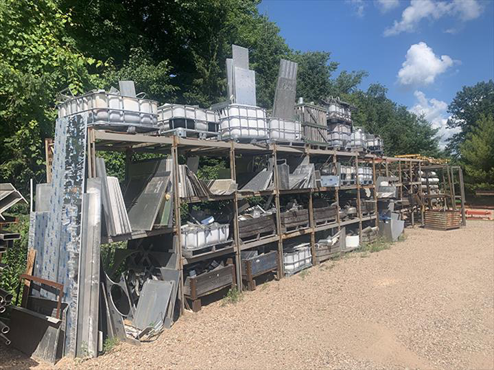 a warehouse filled with lots of containers and pallets .