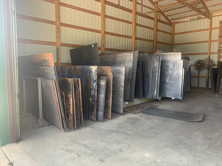 a warehouse filled with lots of metal sheets .