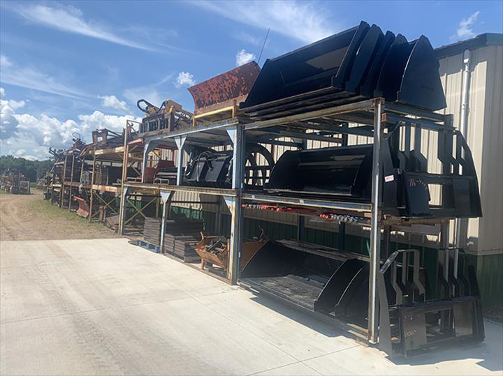 a bunch of buckets are stacked on top of each other in a warehouse .