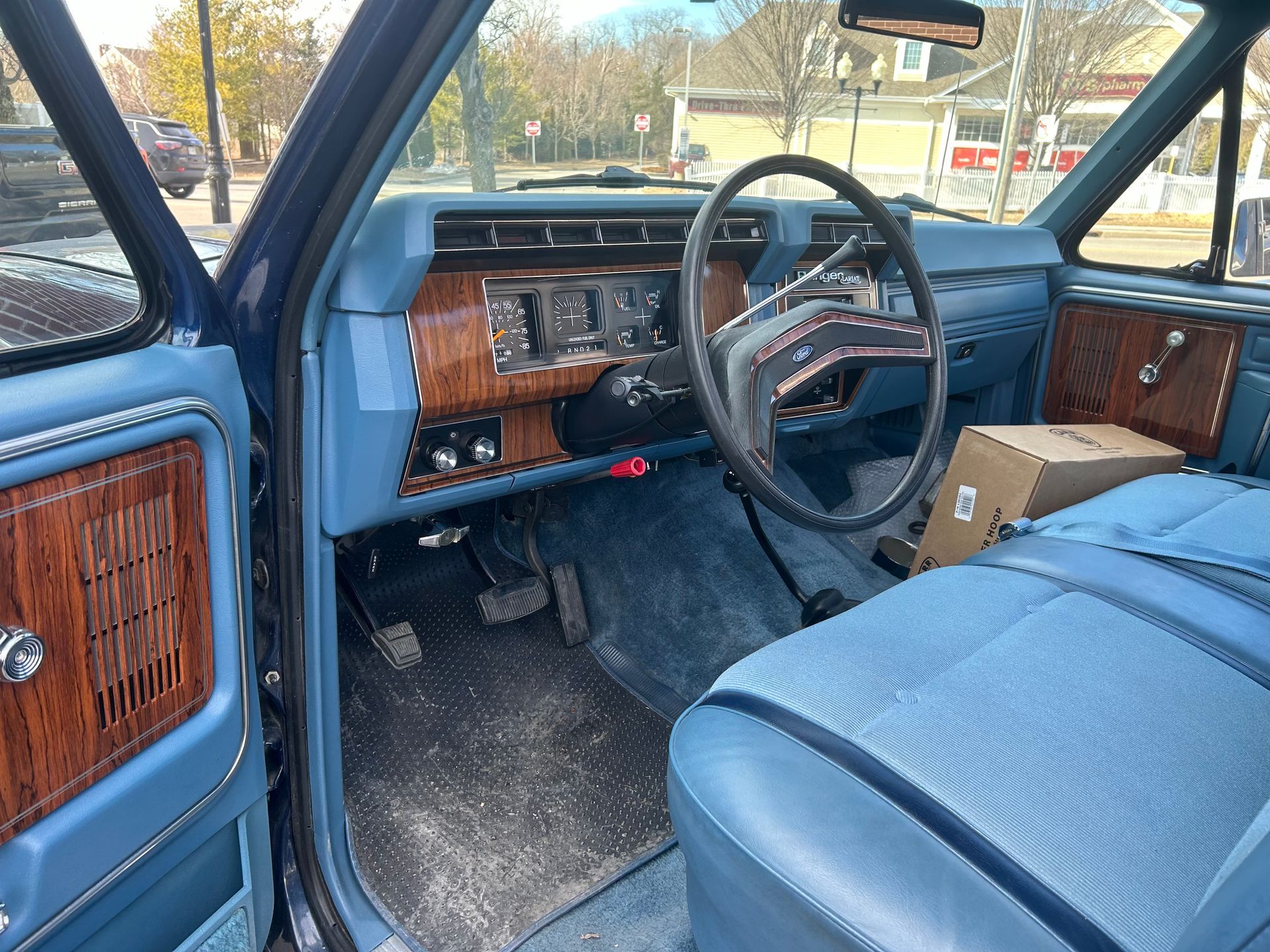 The inside of a blue car with a steering wheel