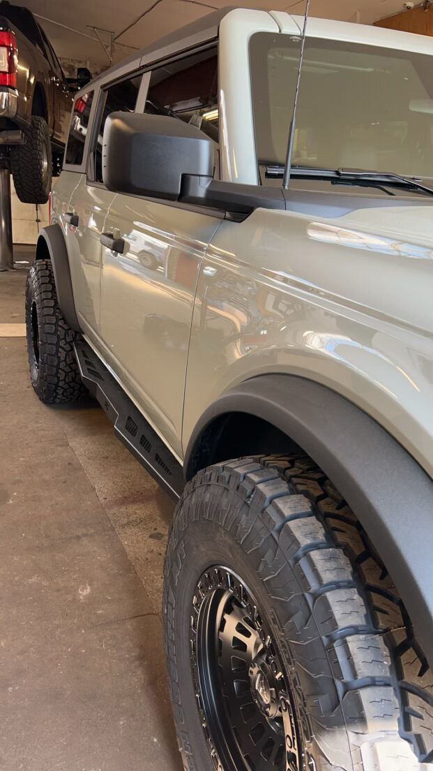 A white Ford Bronco in a garage