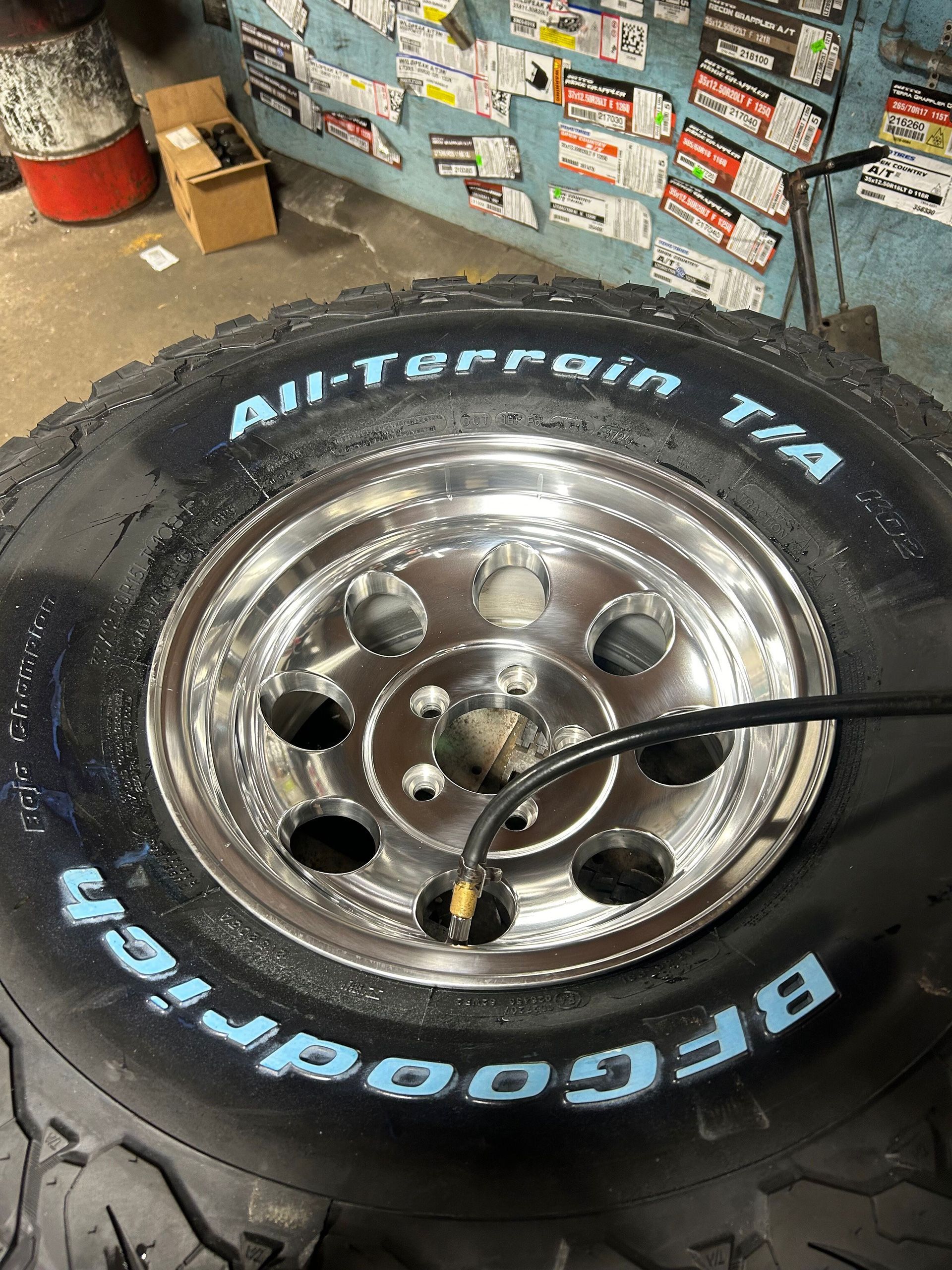 A close up of a tire with a hose attached to it