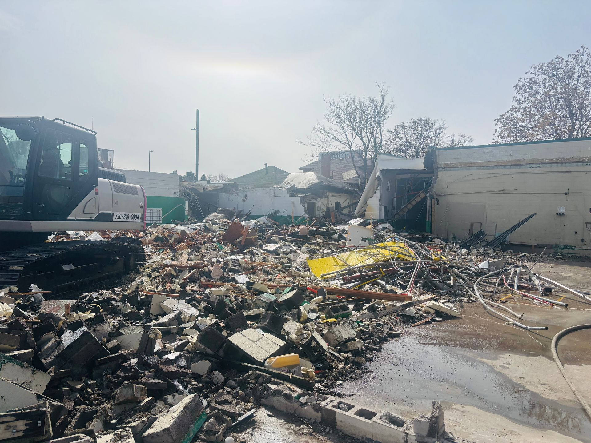 A bulldozer is sitting in the middle of a pile of rubble.