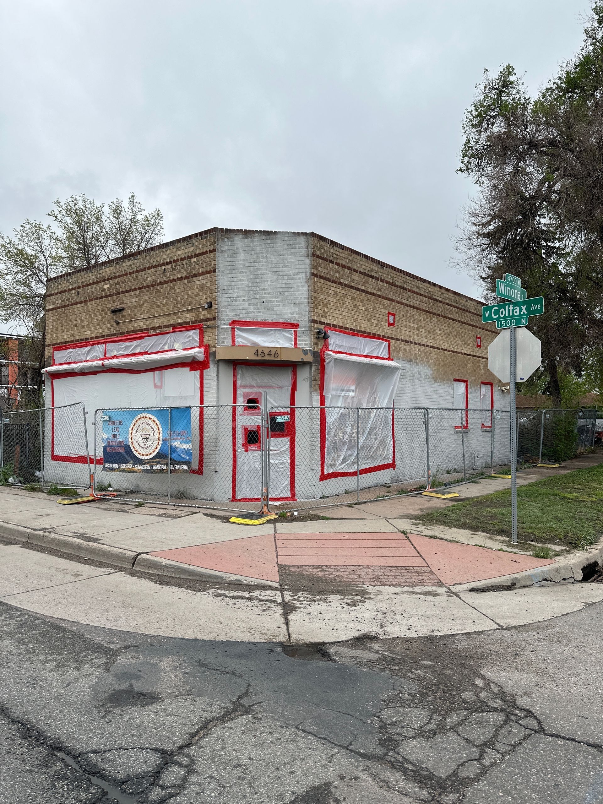 A building is sitting on the corner of a street.