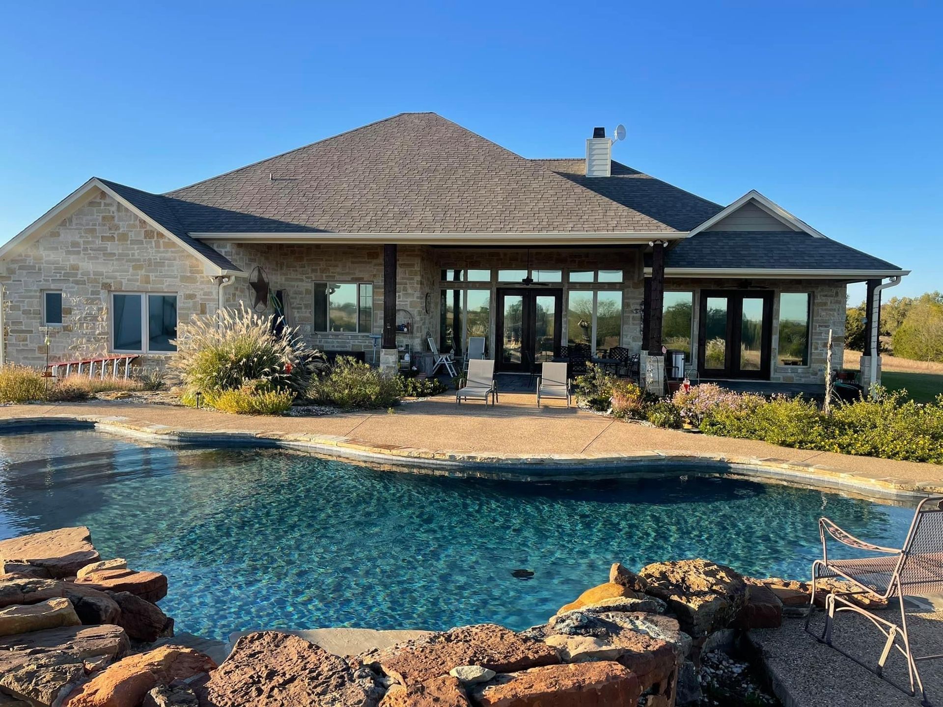 A large house with a large swimming pool in front of it.