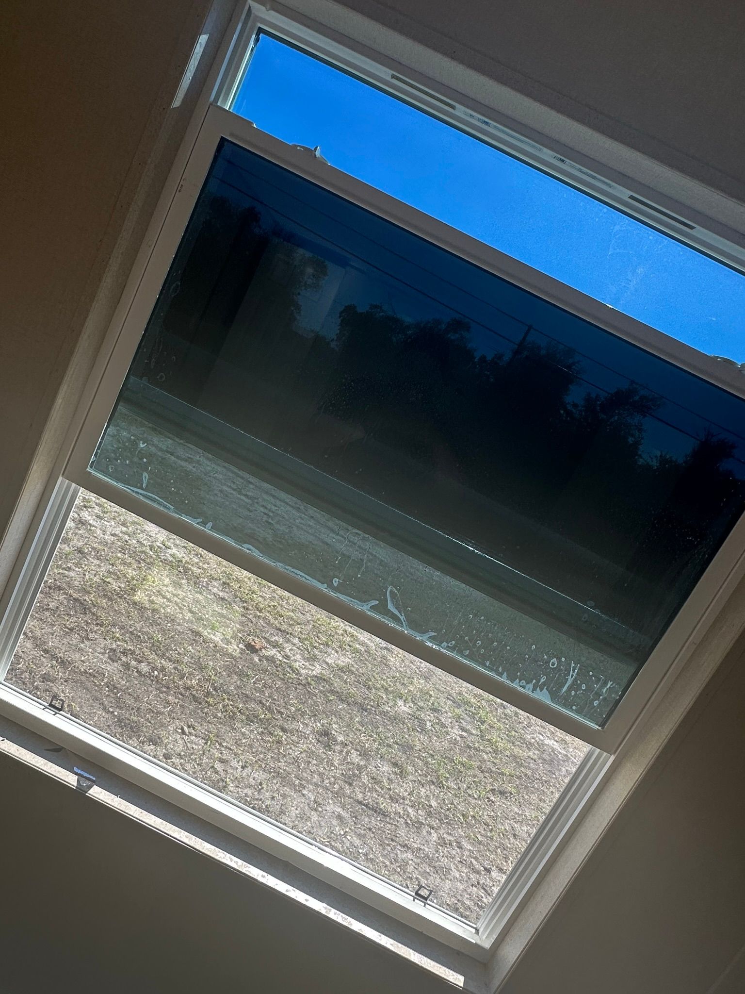 A skylight with a blue sky behind it
