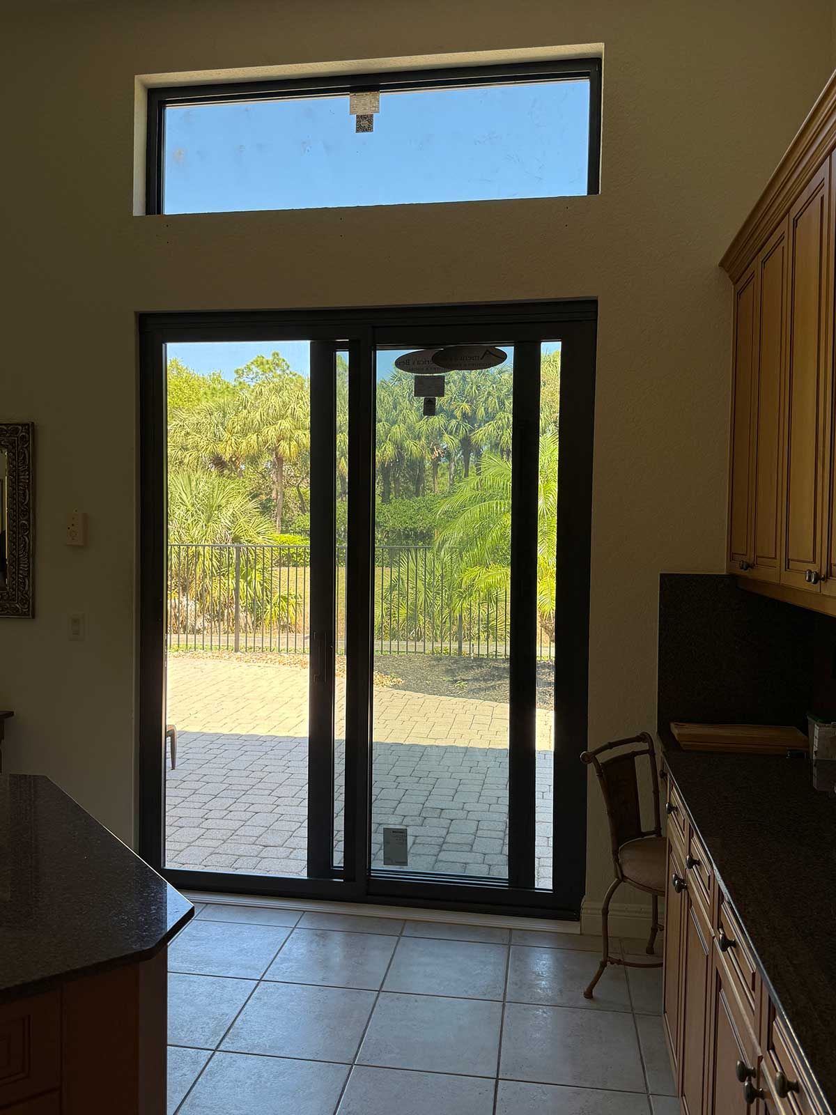 A kitchen with a sliding glass door leading to a patio.