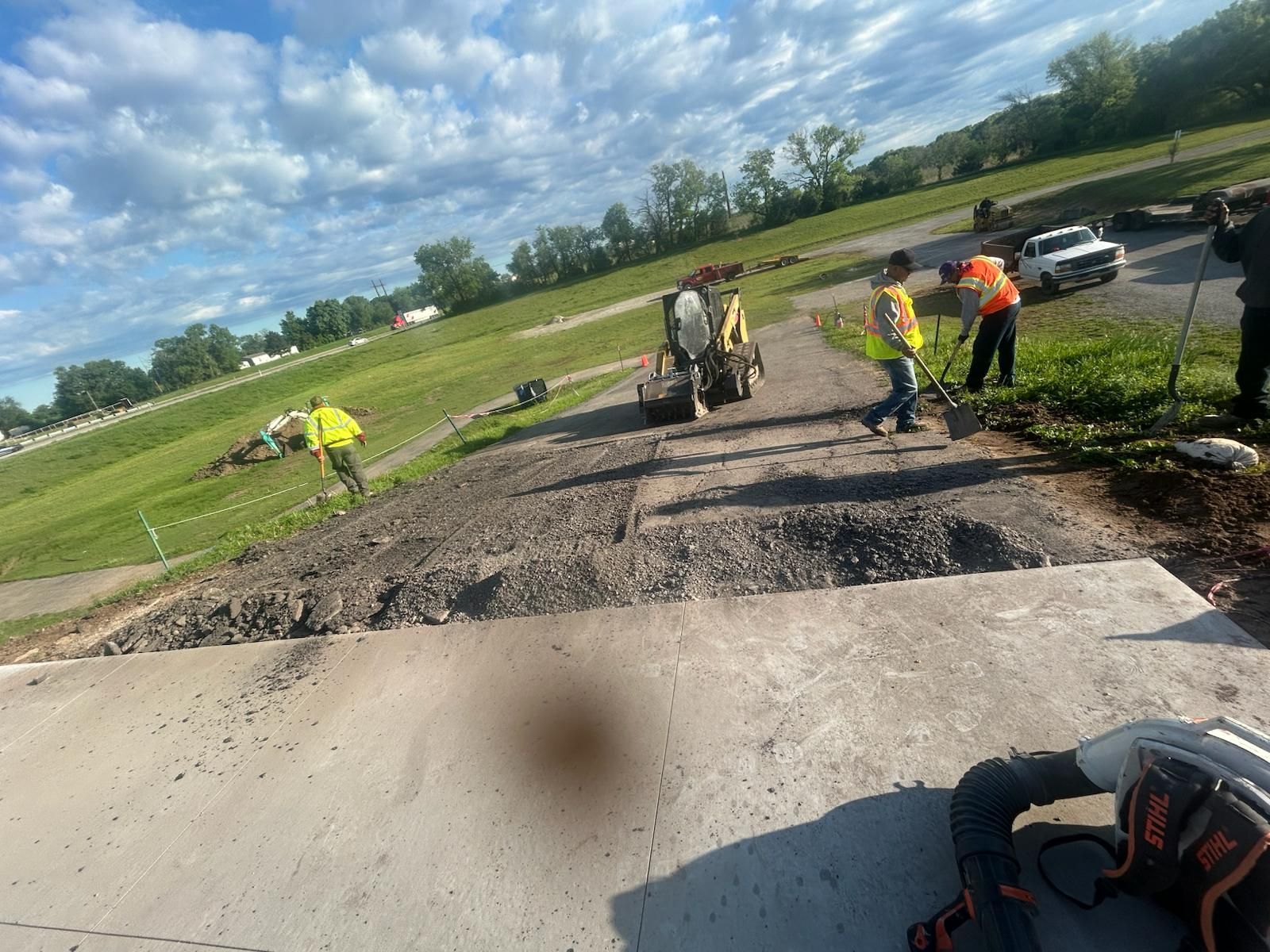 A group of construction workers are working on a road.