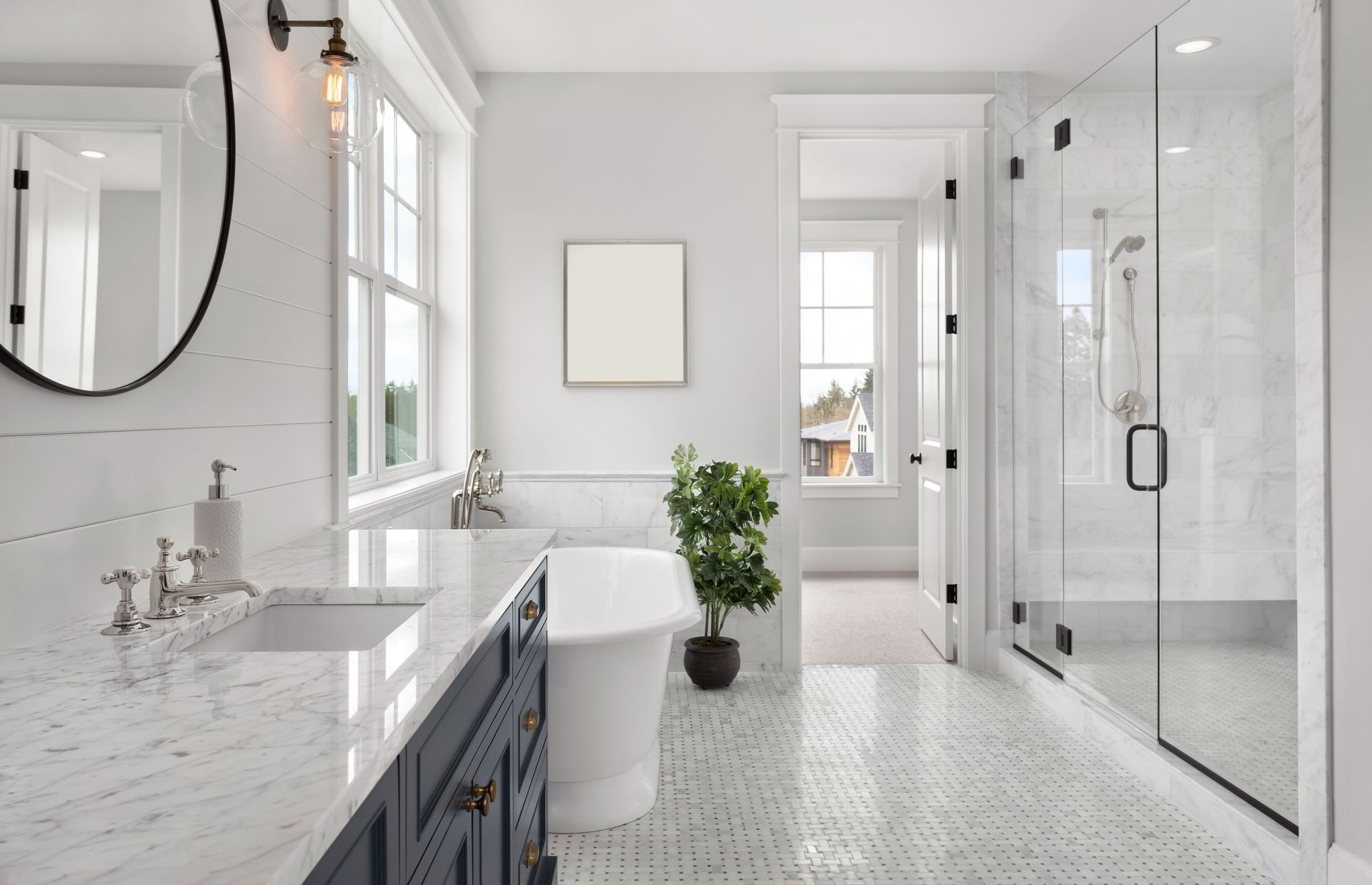 A bathroom with a tub , sink , mirror and shower.