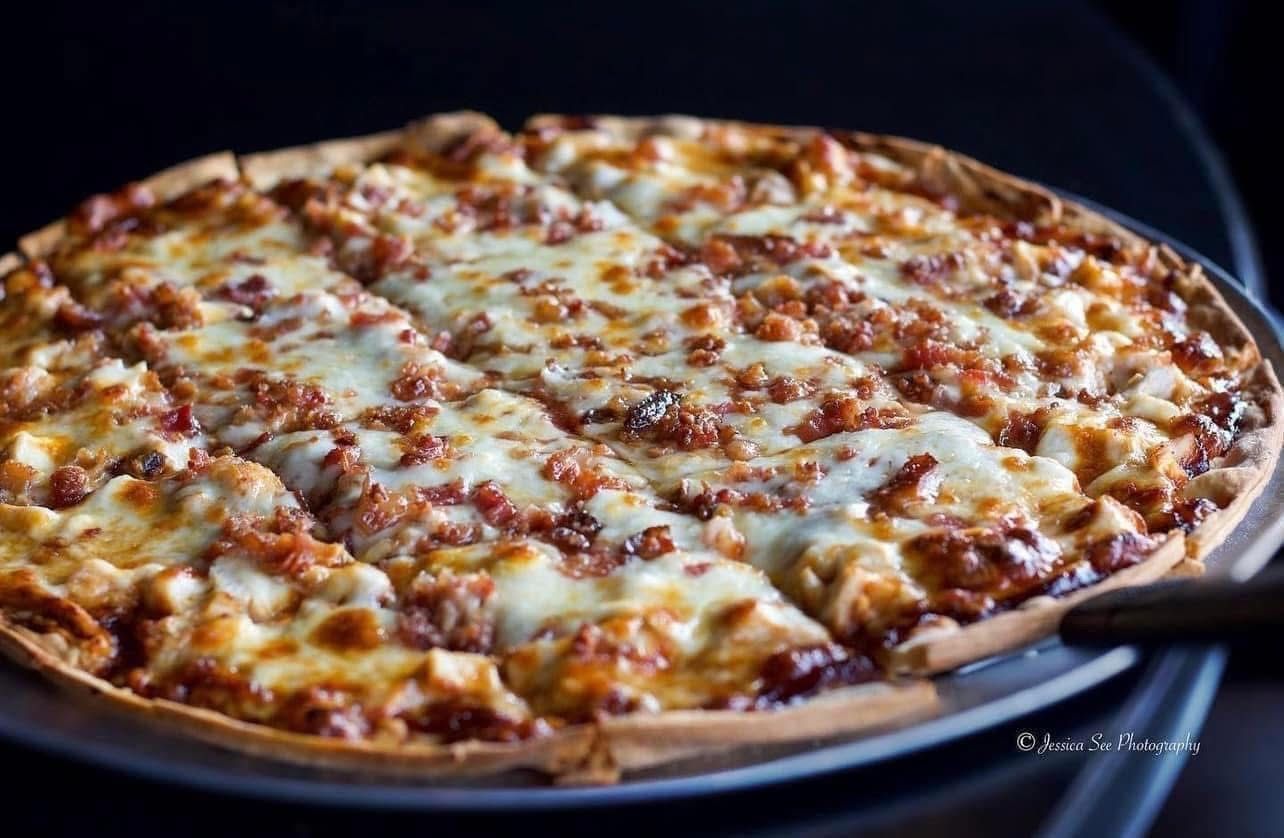 A pizza with a lot of cheese on it is on a pan