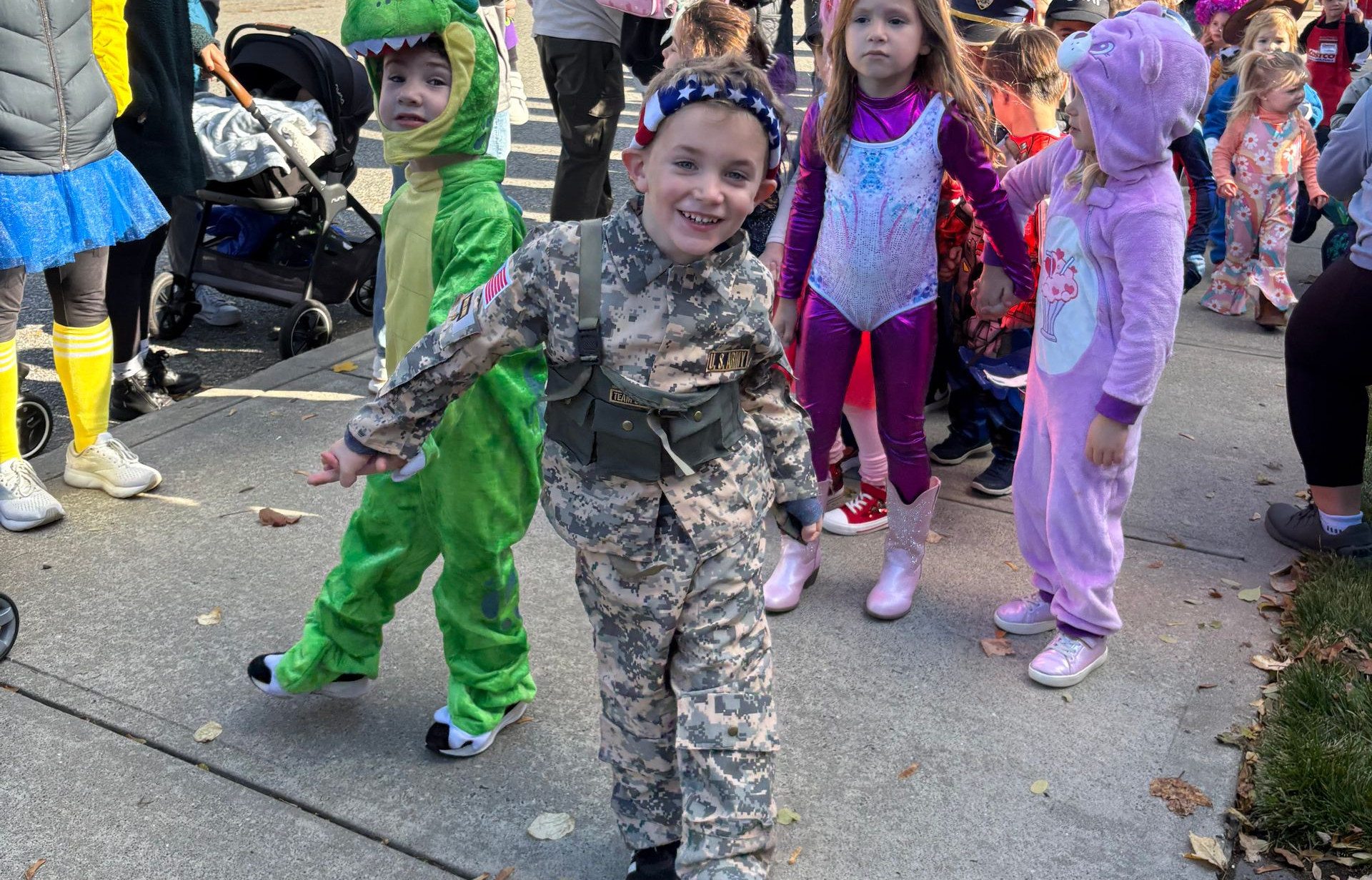 Children and teacher posing in a classroom with a