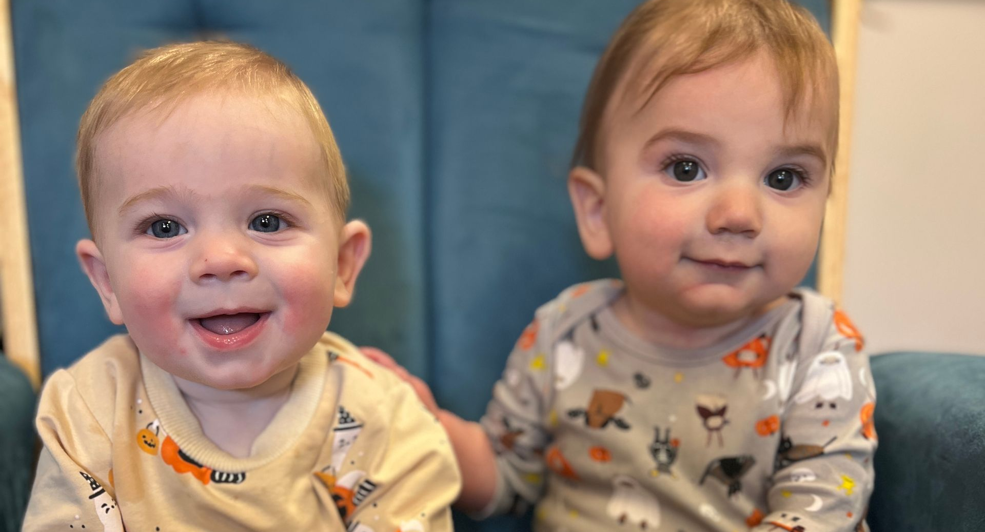 Group of children and teacher posing in front of a 