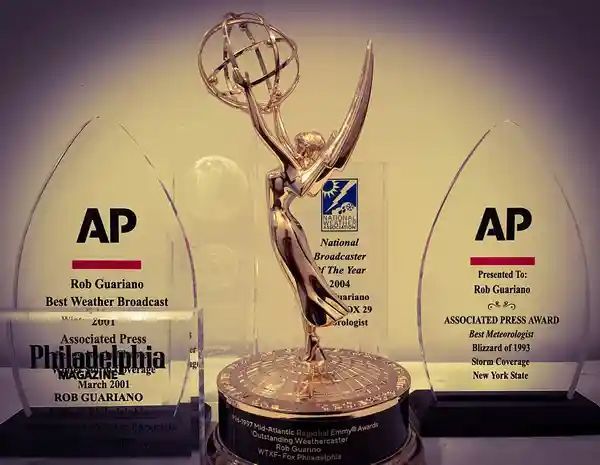 A couple of trophies sitting on top of each other with one that says ap on it