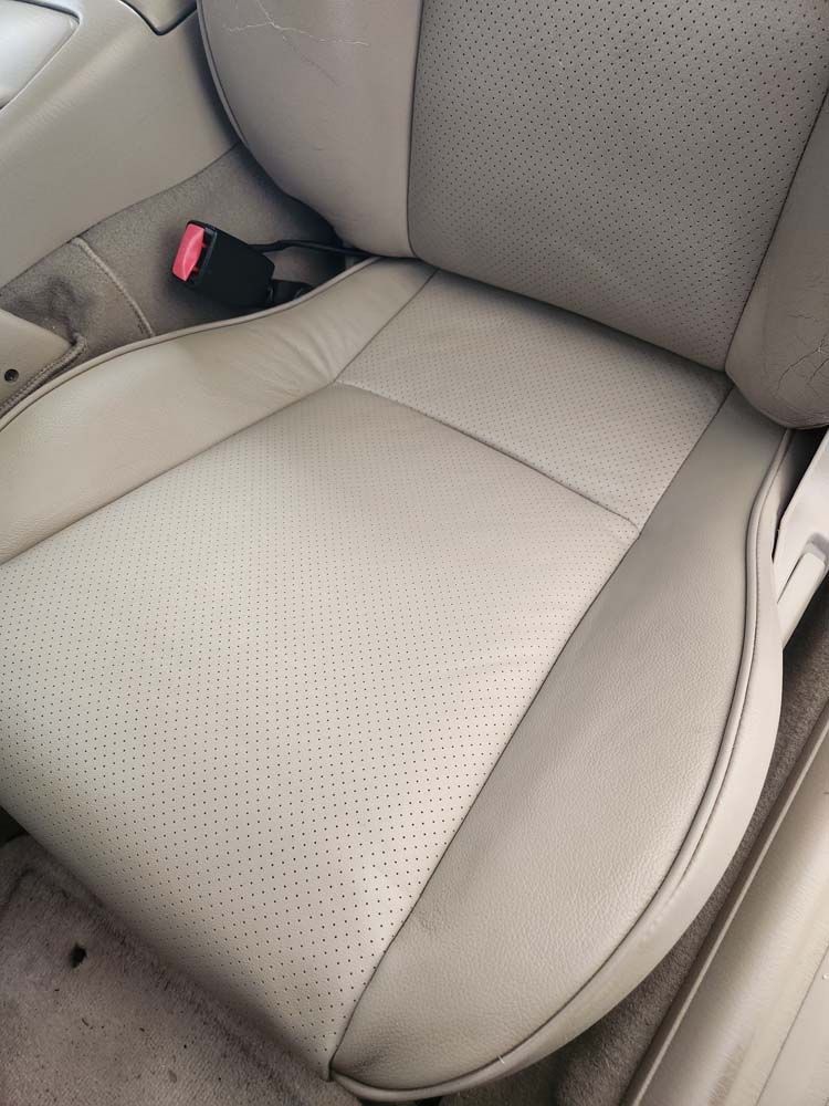 Beige leather car seat with perforated center.