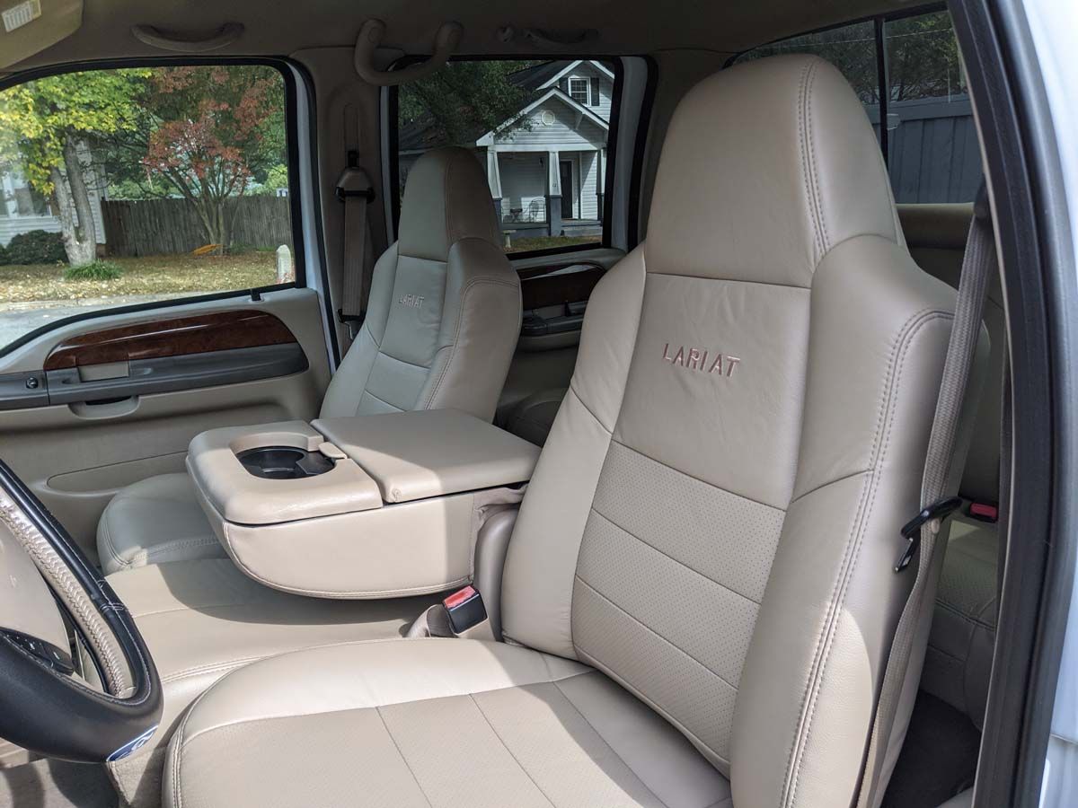 Tan leather truck seats, center console, and steering wheel; view inside the cab.