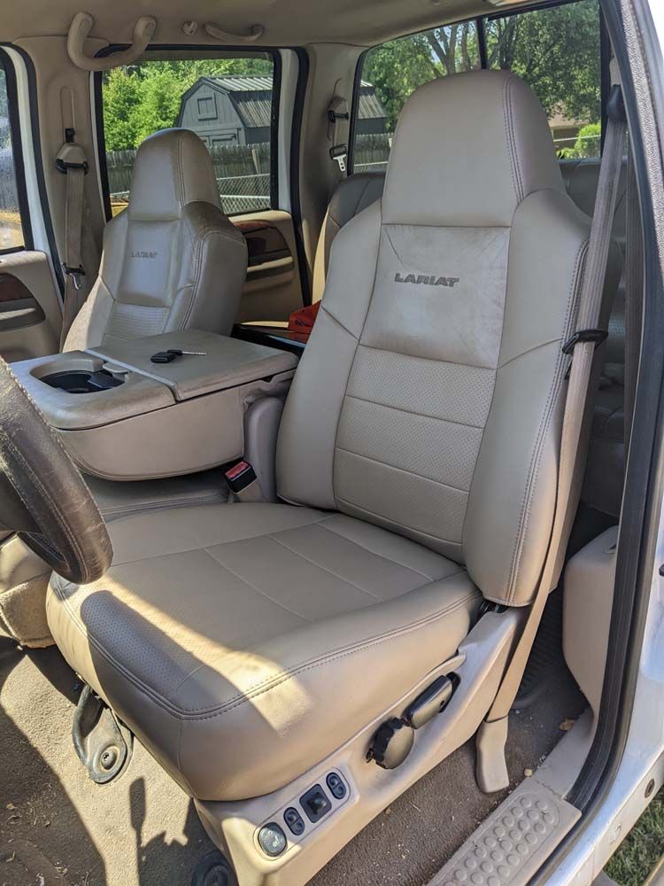 Tan leather truck interior with a front seat, center console, and steering wheel.
