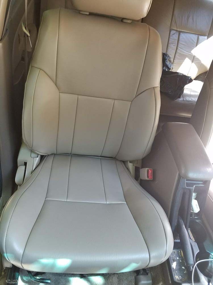 Tan car seat with armrest; interior view.