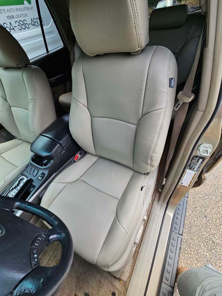 Beige leather car seat in a vehicle interior.