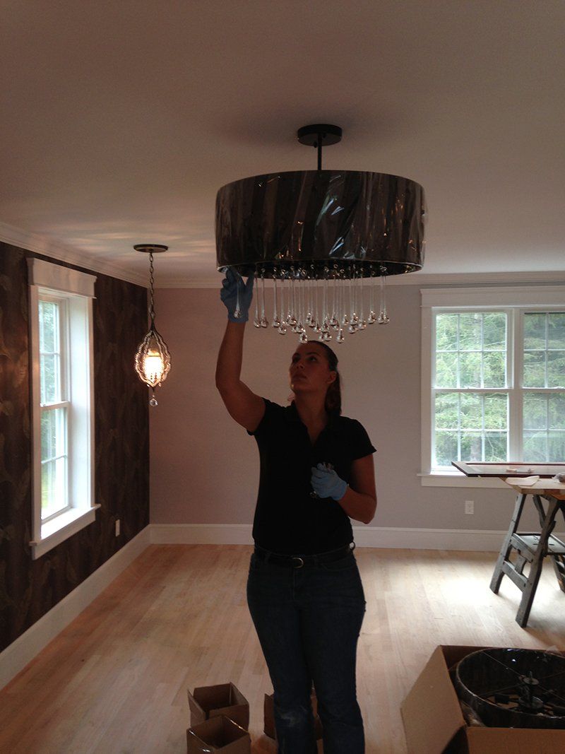 Woman fixing chandelier