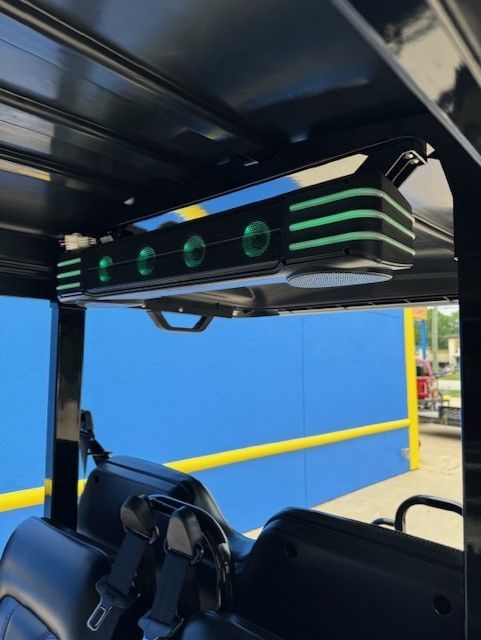 A golf cart with green lights on the roof
