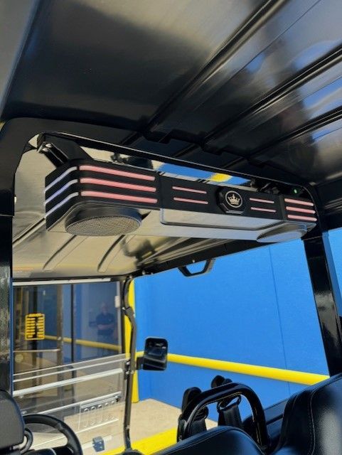 A golf cart with a speaker on top of it