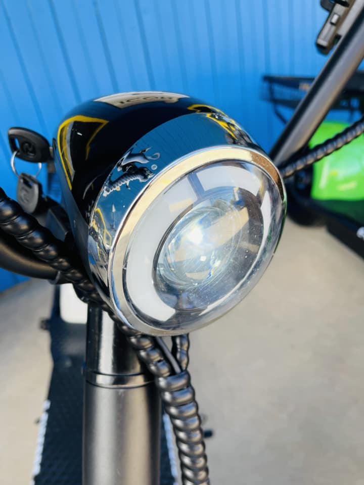 A close up of a headlight on a scooter