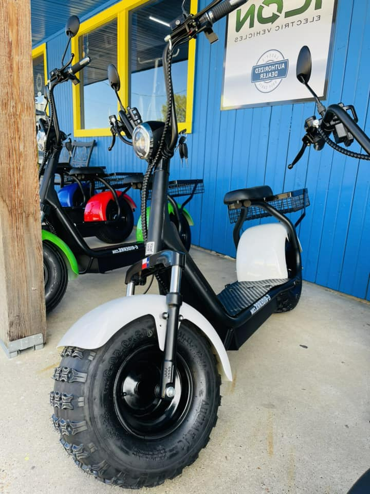 A scooter is parked in front of a blue building