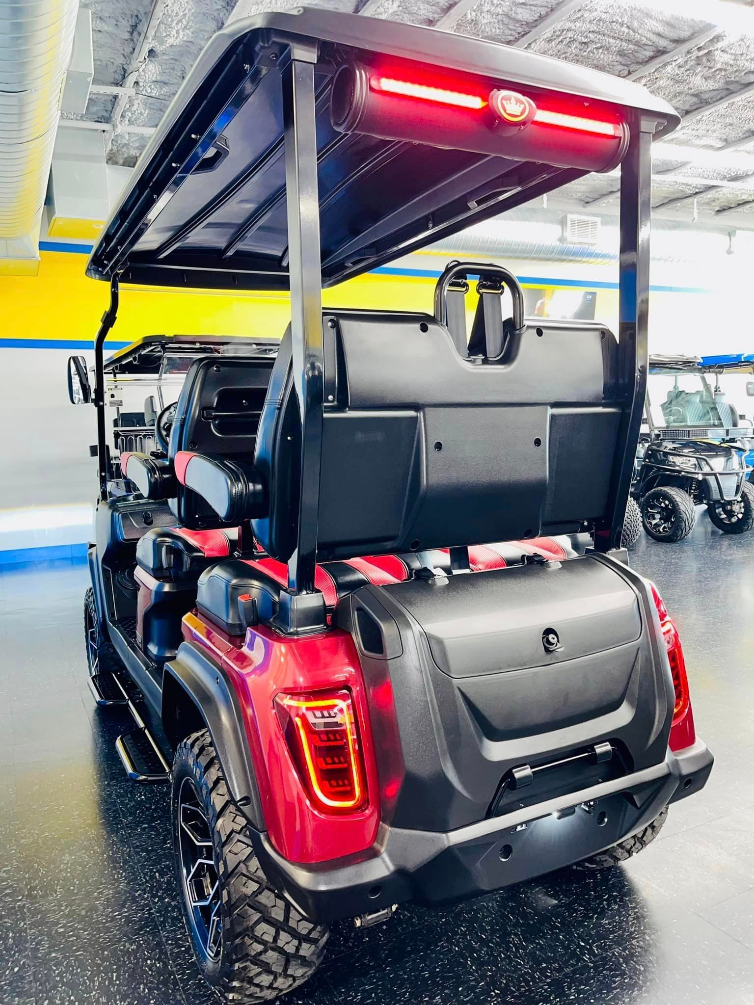 A red golf cart is parked in a showroom.