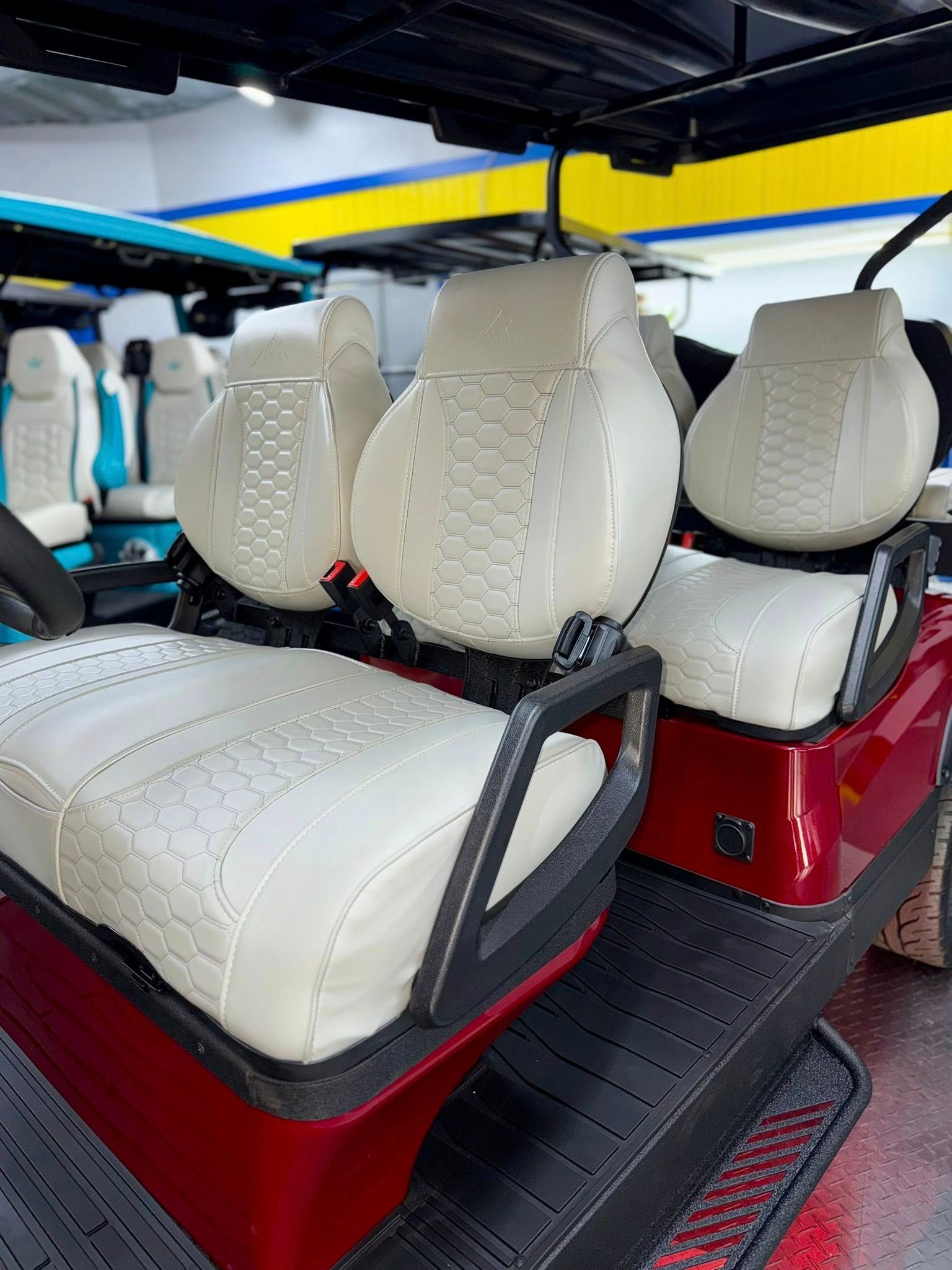 Red golf cart with white, patterned seats.