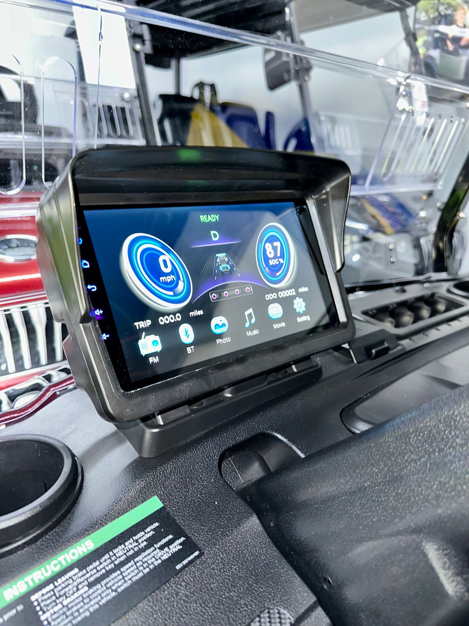A car dashboard with a tablet sitting on top of it.