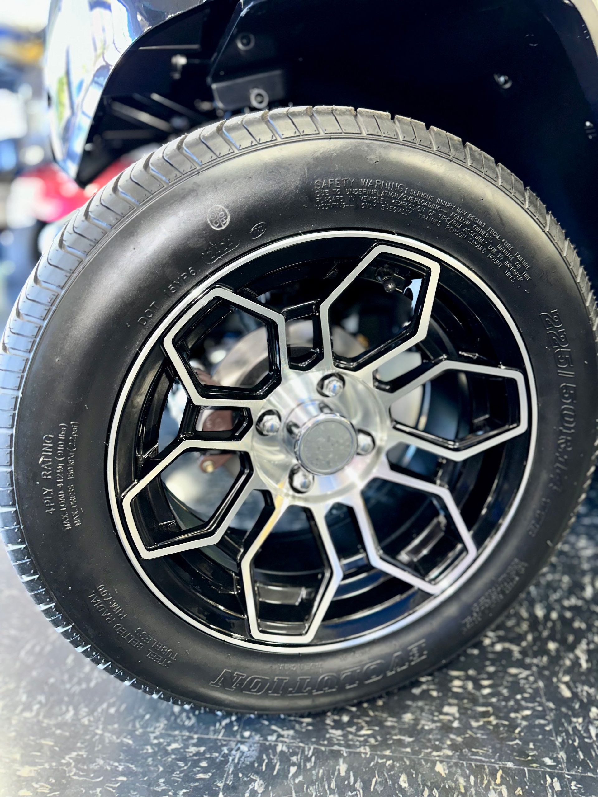 A close up of a wheel on a golf cart.