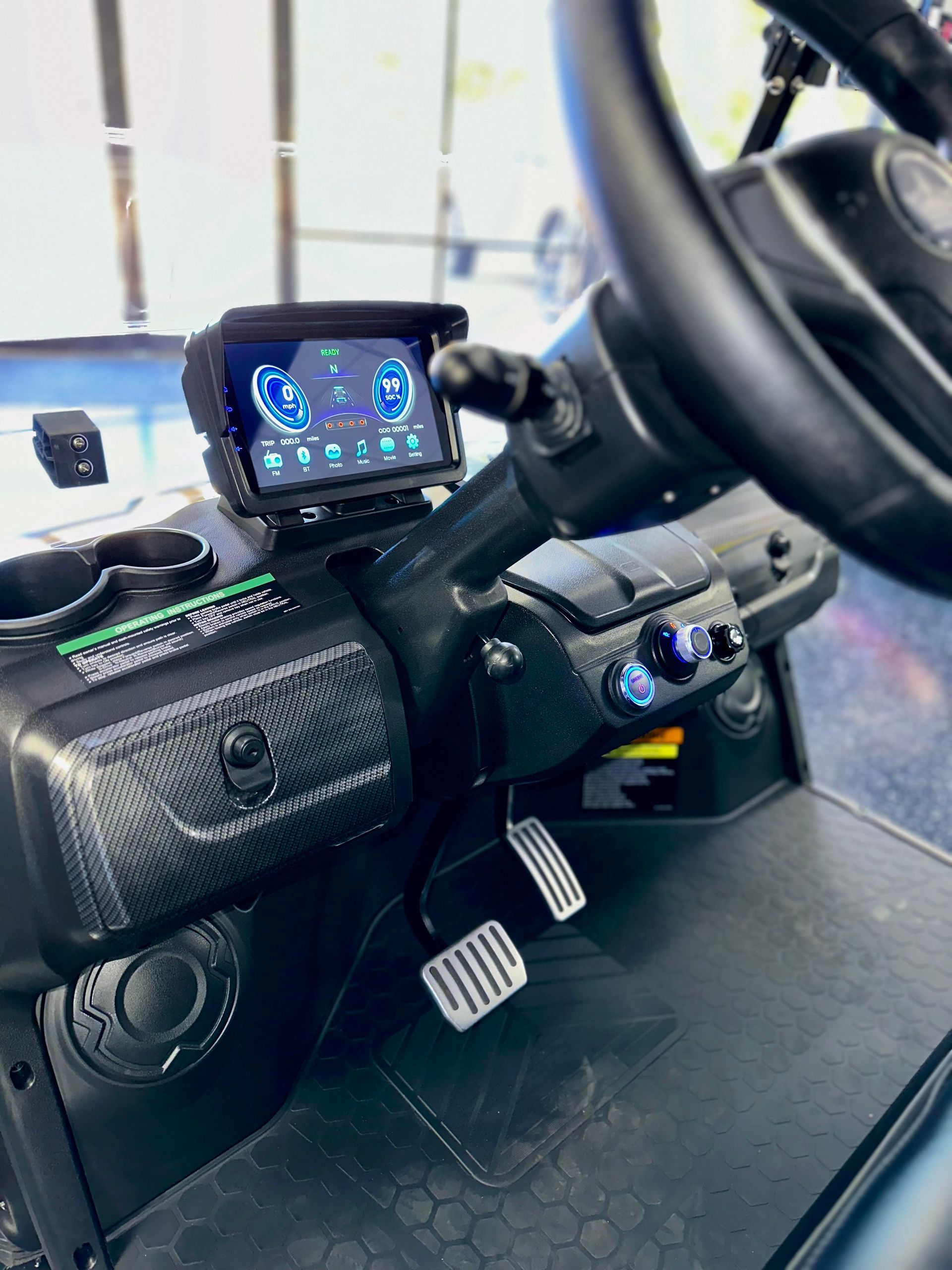 The interior of a golf cart with a steering wheel and dashboard.