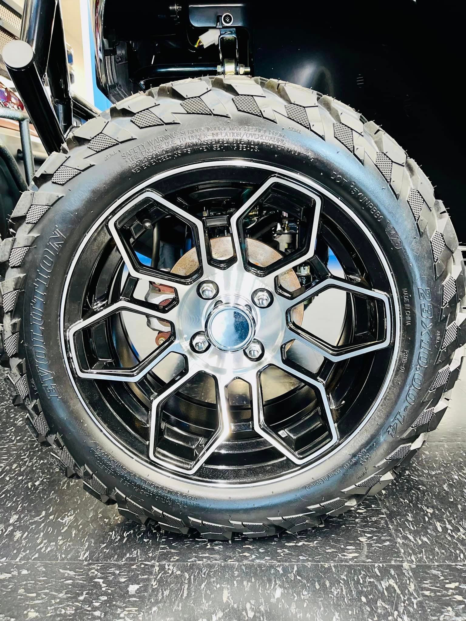A close up of a wheel and tire on a golf cart.