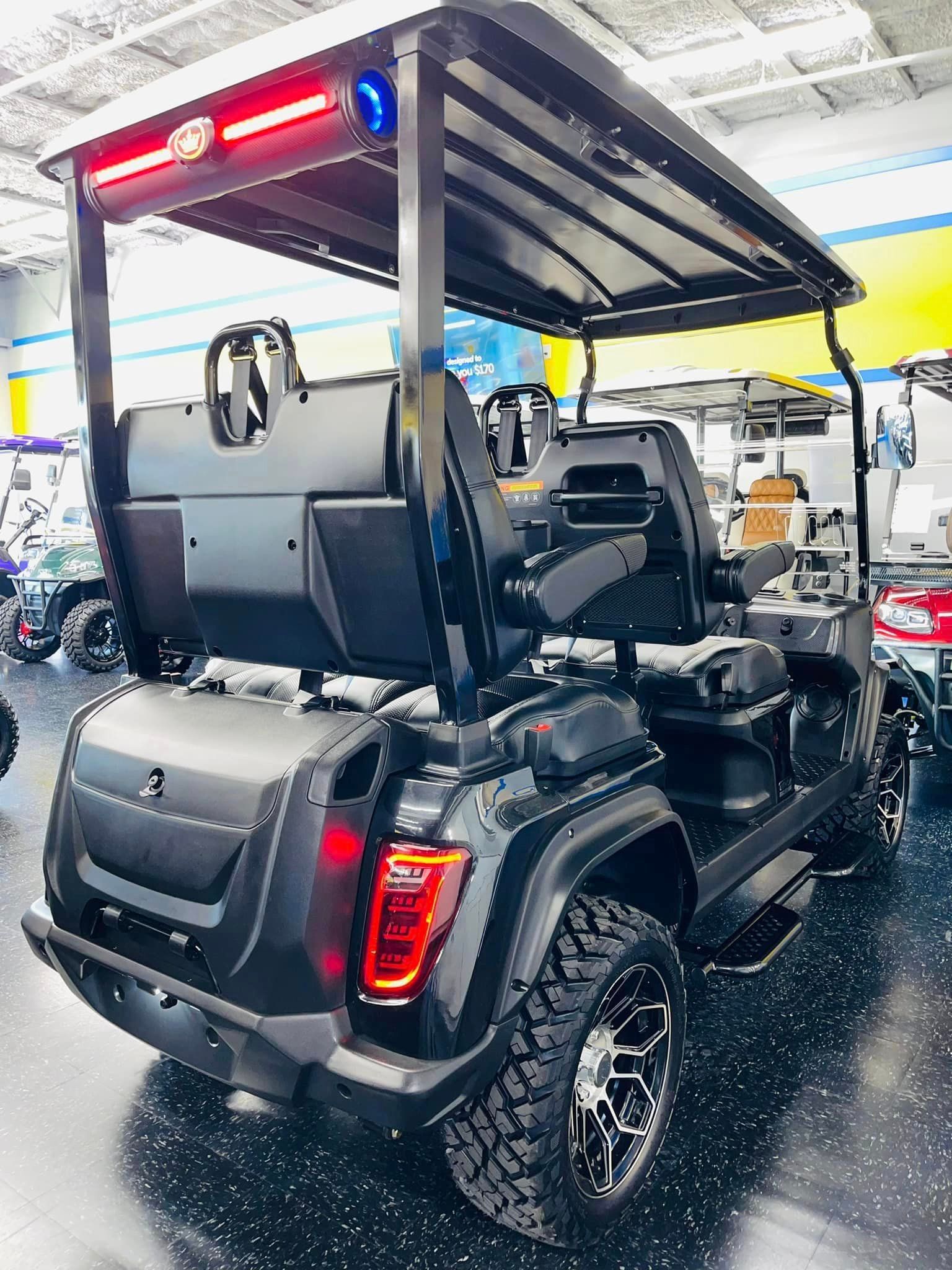 A black golf cart is parked in a showroom.