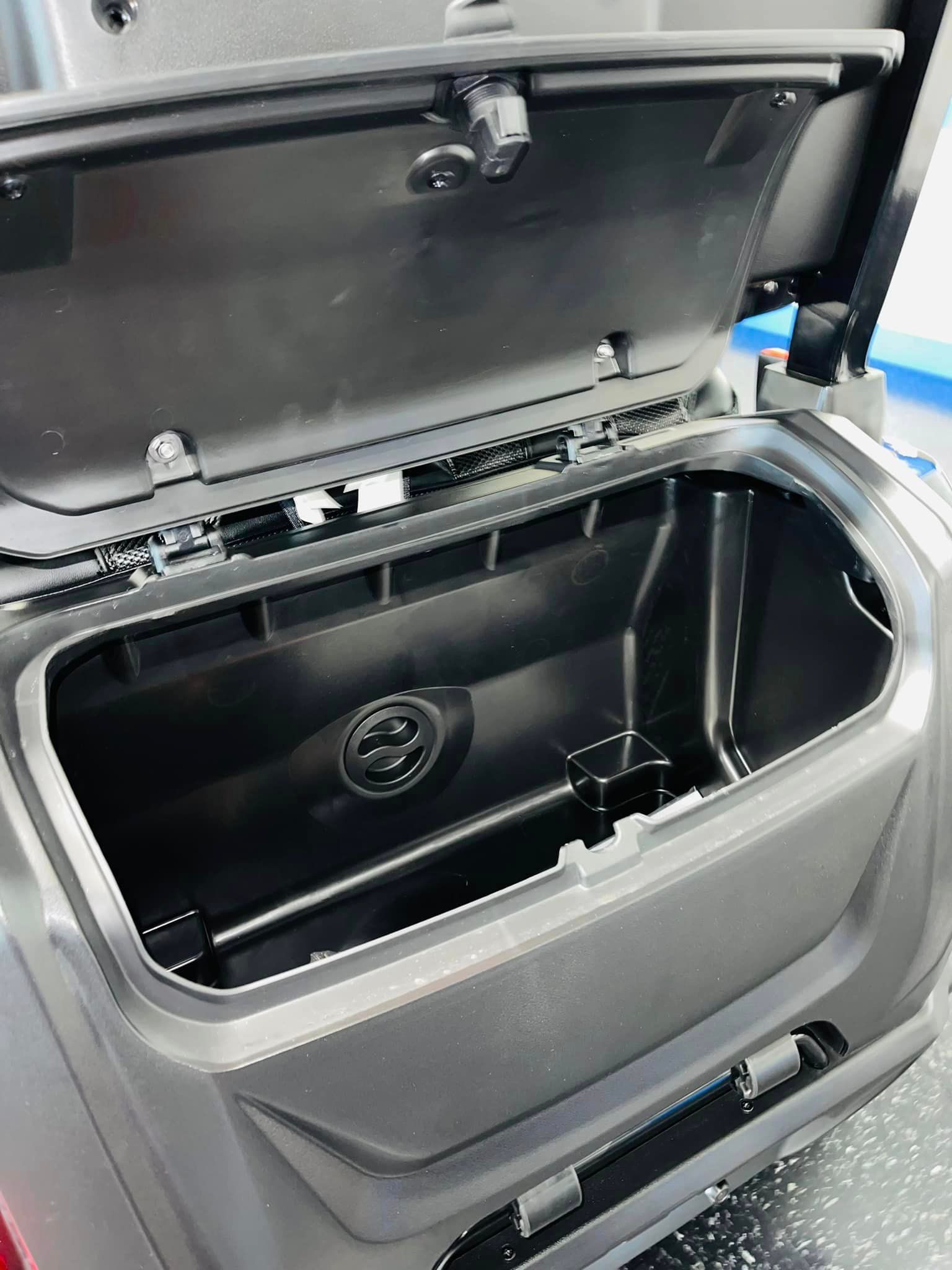 A close up of the trunk of a vehicle with the lid open.